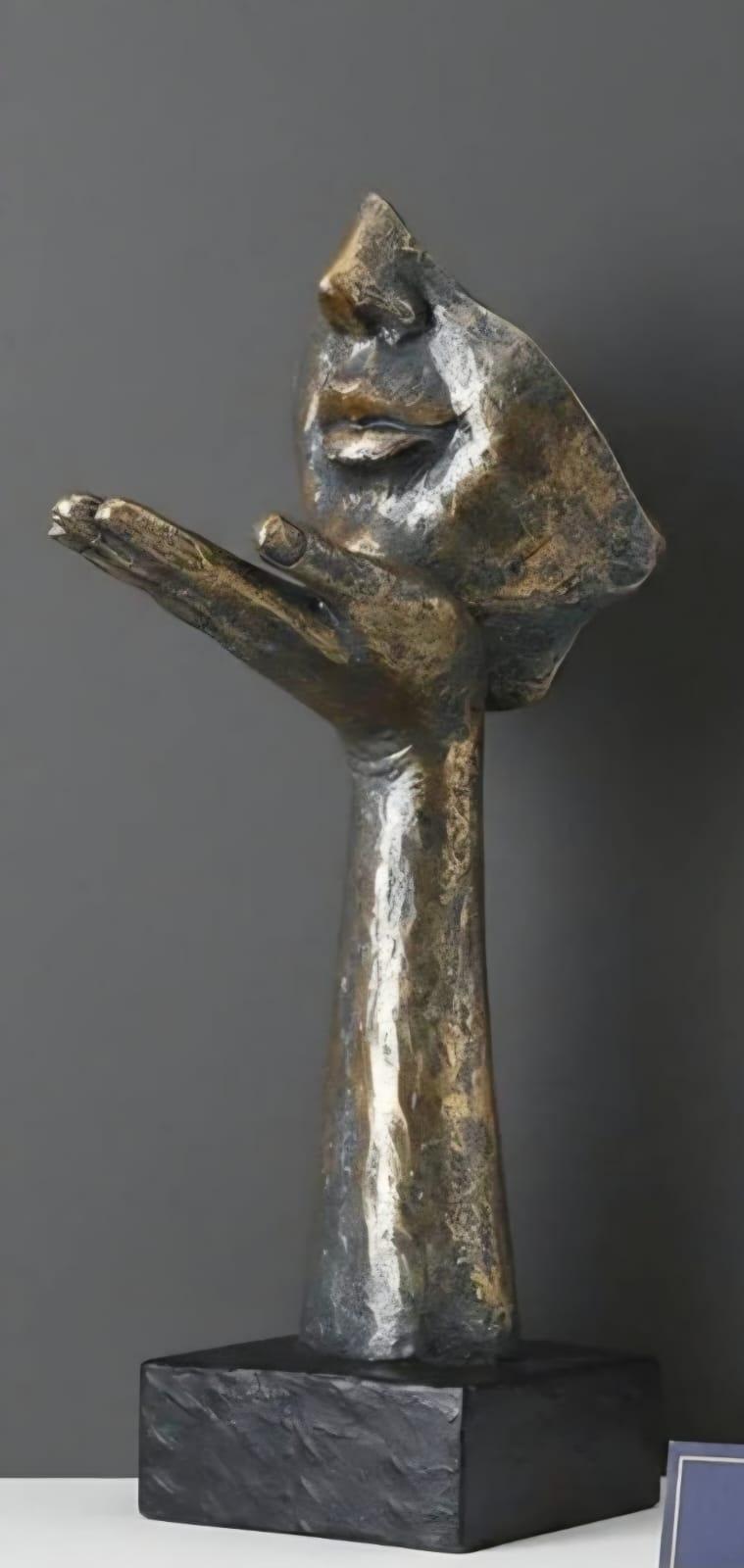 Sculpture visage dans la main, effet bronze